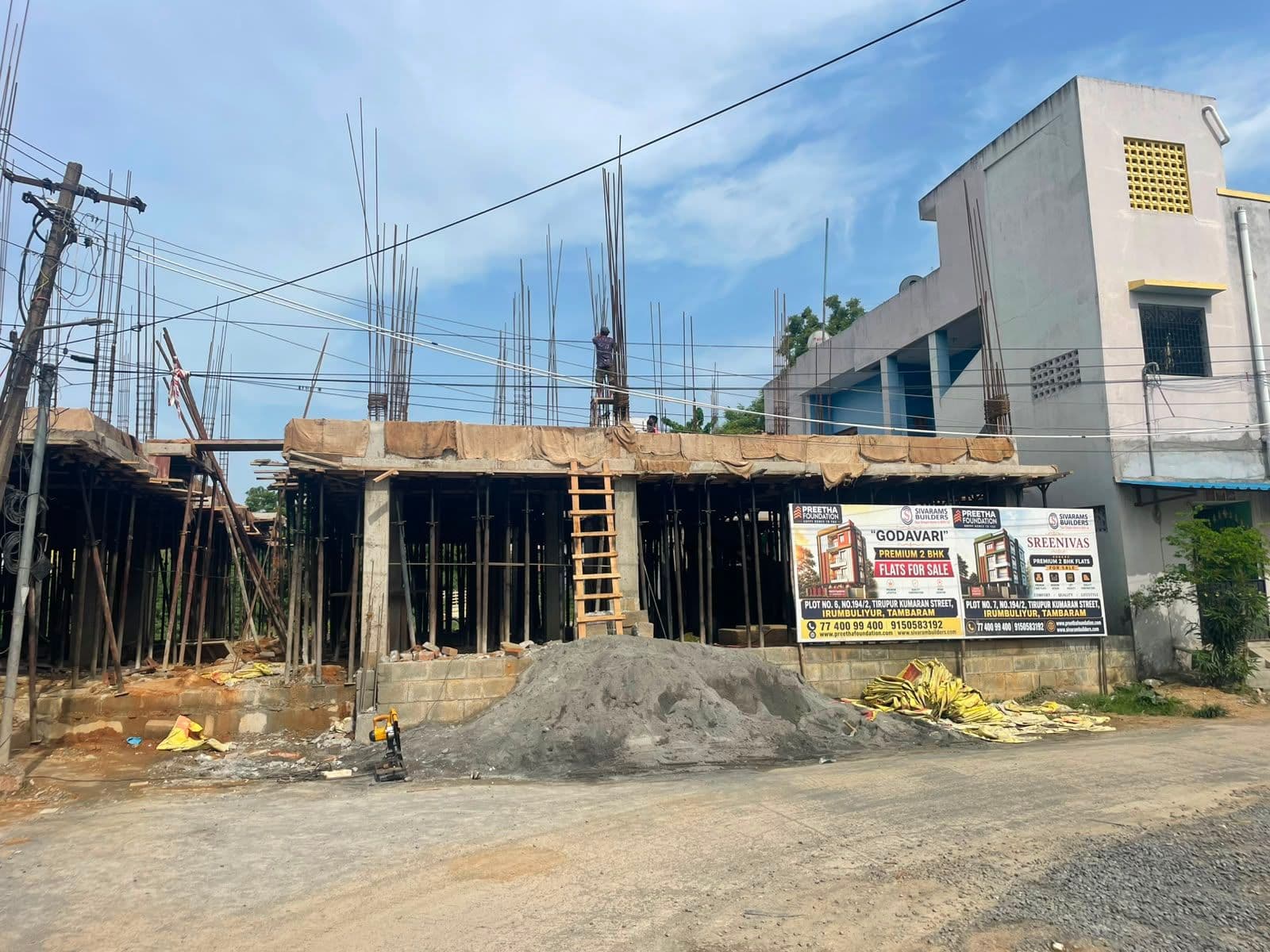 Sreenivas & Godavari Flats, Tambaram West — site under construction, RCC column casting stage, with project signboards